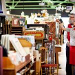 Is buying used furniture worth the cost savings? Quirky vintage couple shopping together in antiques emporium